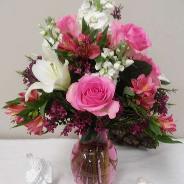 Pink and white mixed bouquet in a pink glass vase