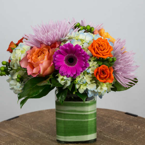 Colorful mixed bouquet in a striped glass vase