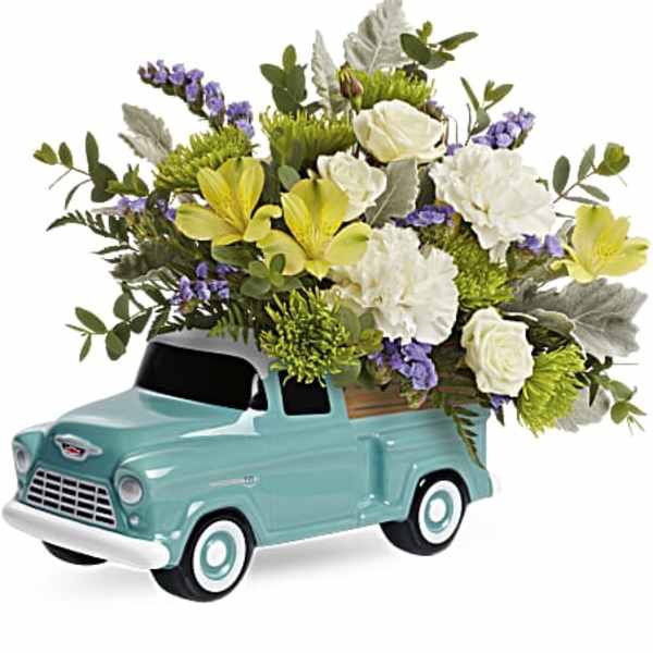 Floral arrangement in a turquoise vintage truck container