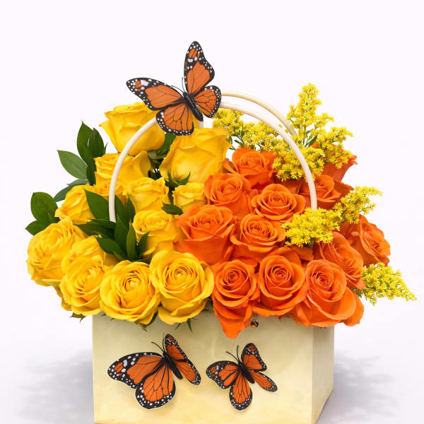 Yellow and orange roses in a box with butterfly decorations