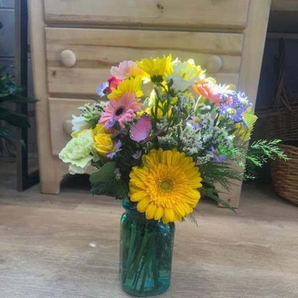 Colorful mixed bouquet in a blue glass vase