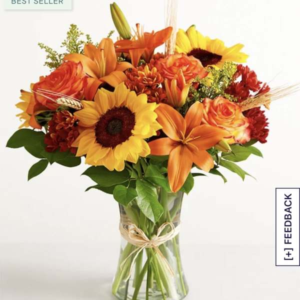 Orange and yellow mixed bouquet in a clear glass vase