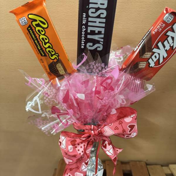 Candy bouquet with Reese's, Hershey's, and Kit Kat bars in pink wrap