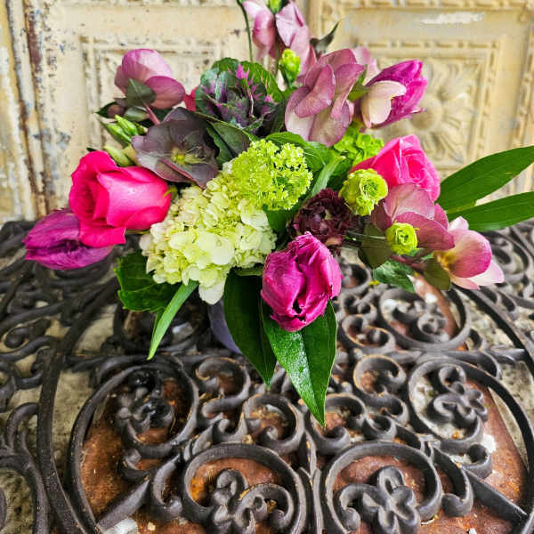 Bouquet of pink roses and purple blooms with green hydrangea