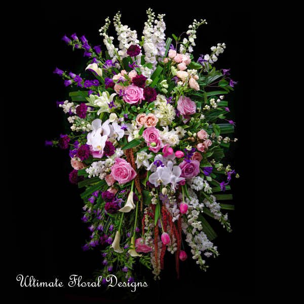 Large standing floral spray with pink, white, and purple blooms