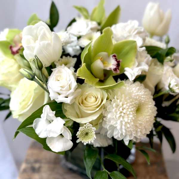 White and pale green bouquet with roses, orchids, and mums