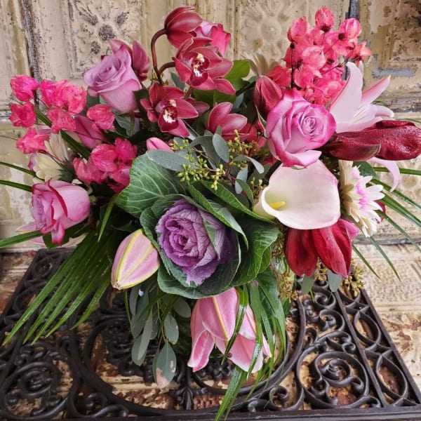 Mixed bouquet with pink roses, orchids, calla lilies, and purple cabbage