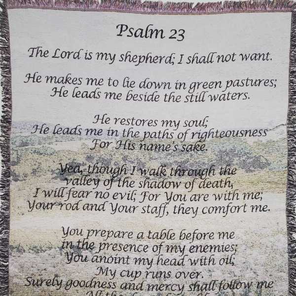 A decorative wall hanging with Psalm 23 text over a pastoral scene