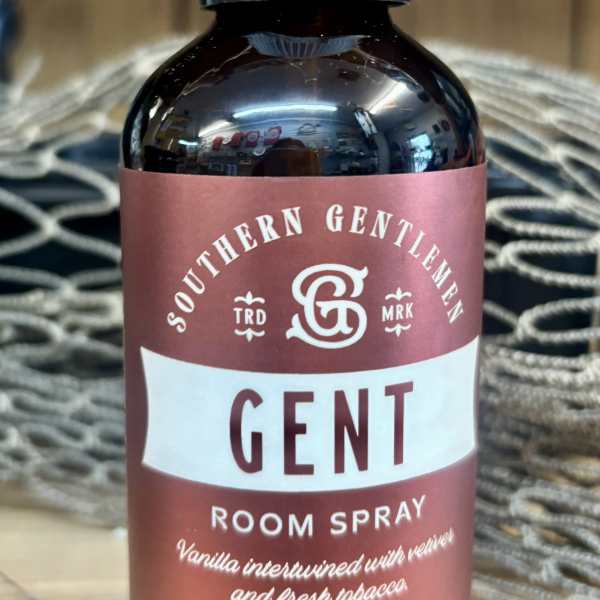 Brown room spray bottle with a clear cap and maroon label