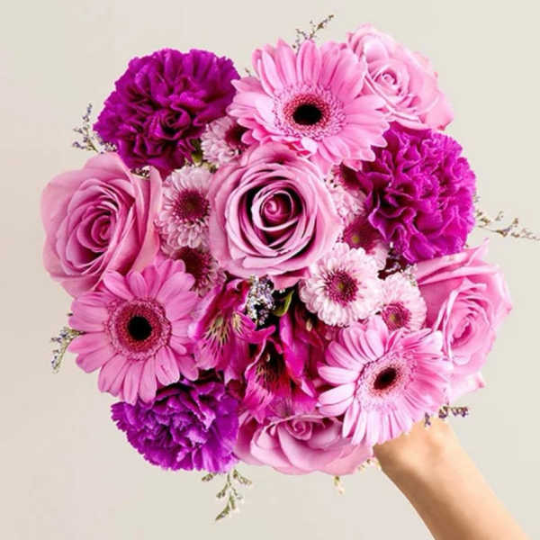 Pink and purple bouquet with roses, gerbera daisies, and carnations