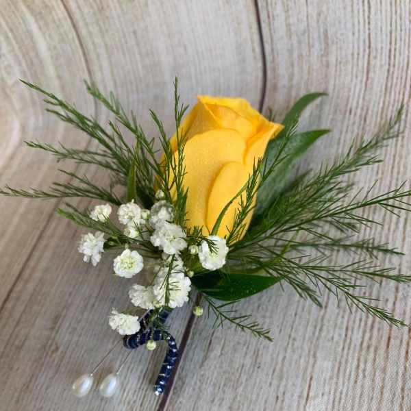Yellow rose boutonniere with white baby's breath and greenery