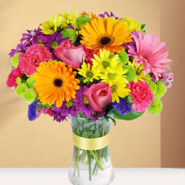 Colorful bouquet of mixed flowers in a clear glass vase