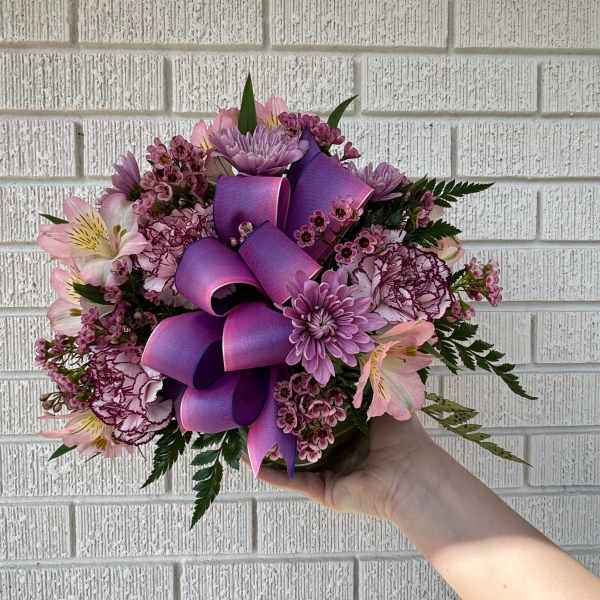 Pink and purple bouquet with a large ribbon bow