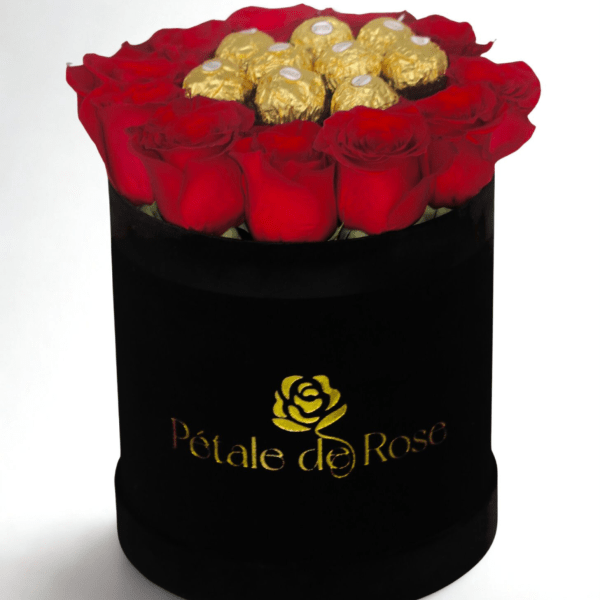Round black hatbox with red roses surrounding gold-wrapped chocolates on top