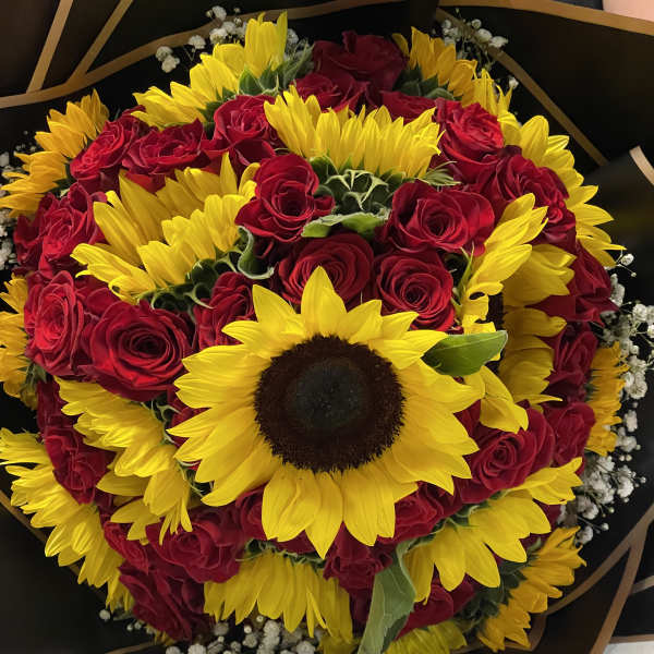 Bouquet of red roses and yellow sunflowers wrapped in black paper