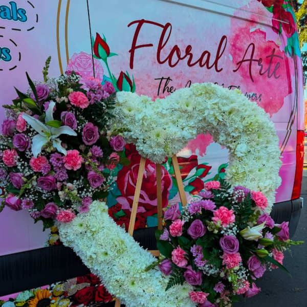 Large floral heart wreath on easel with pink and white flowers