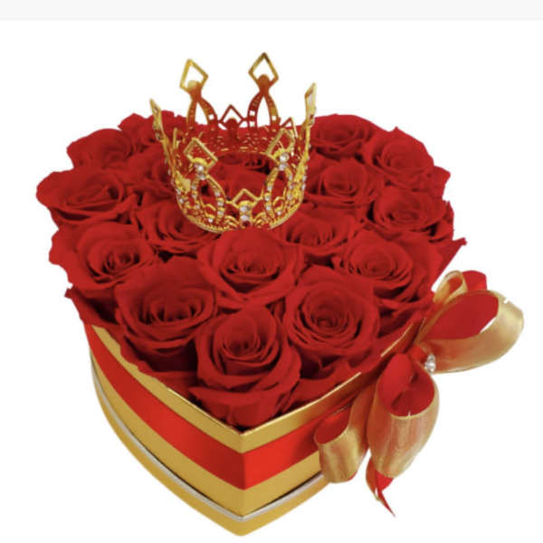Heart-shaped box of red roses with a gold crown topper