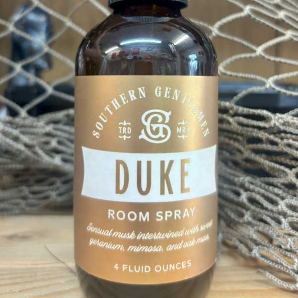 Brown room spray bottle with a pump top and gold label