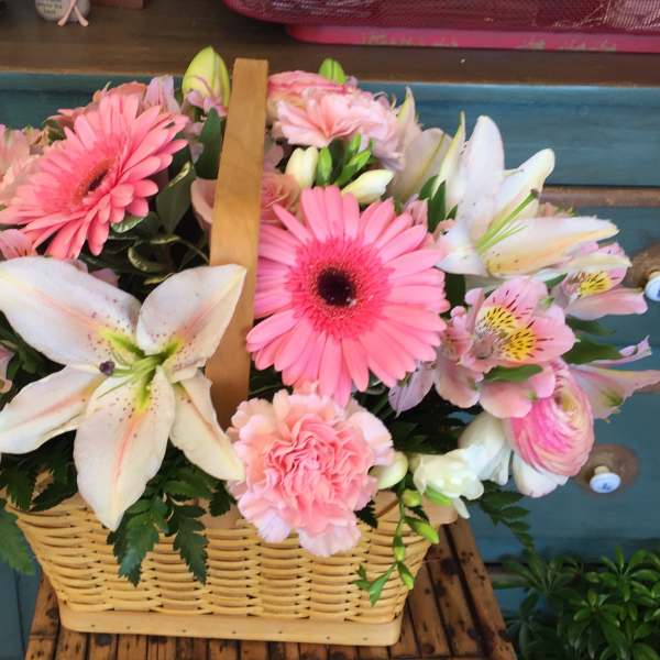 Pink and white mixed flower basket with lilies, gerberas, roses, and carnations