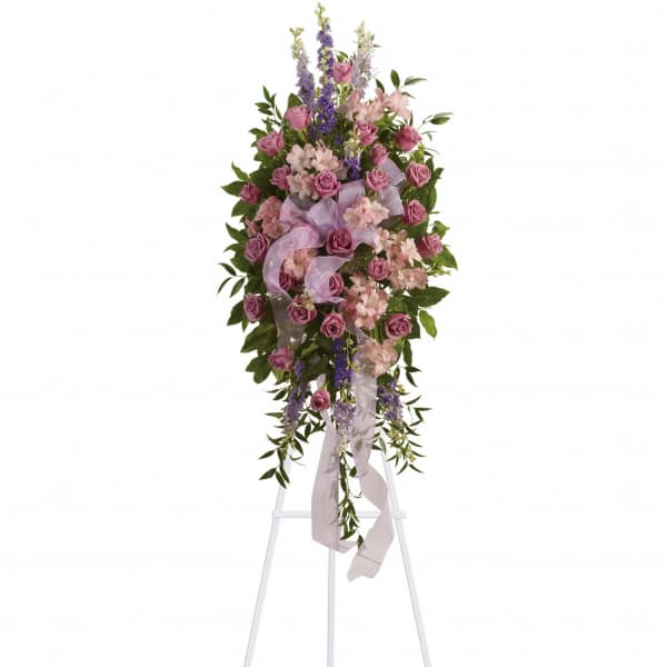 Standing floral spray of pink roses and lavender flowers on an easel