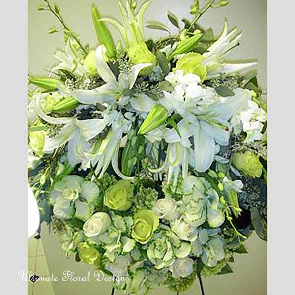 Large white and green floral arrangement with lilies and roses