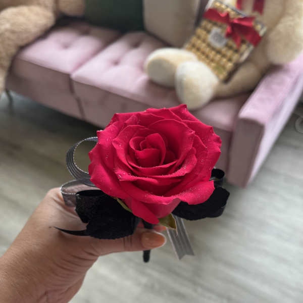 Single red rose corsage with black ribbon accents