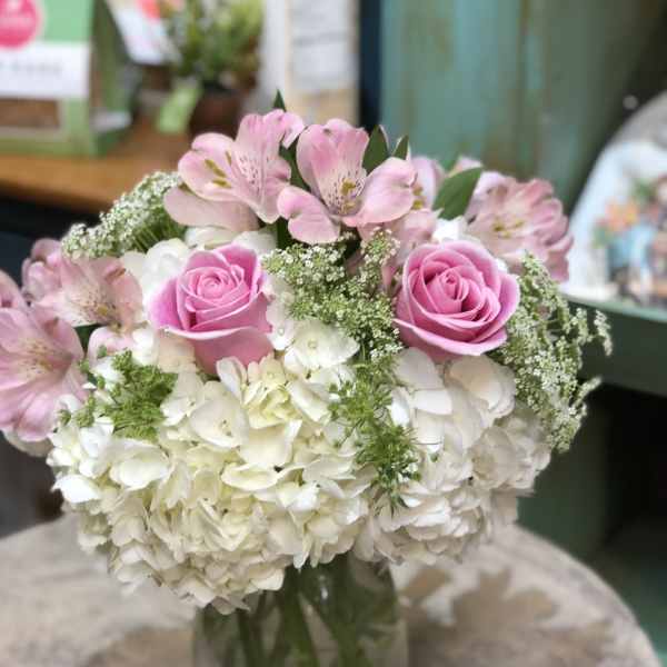 Pink roses and white hydrangeas in a glass vase