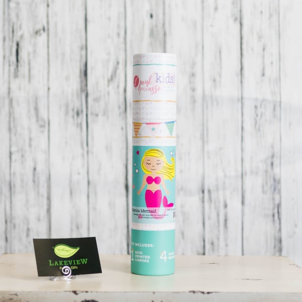 A rolled kids mermaid canvas kit stands on a table.