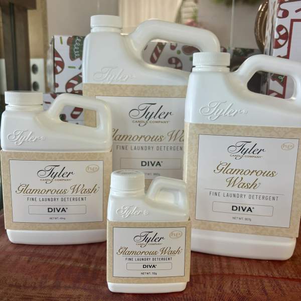 Four bottles of Tyler Glamorous Wash laundry detergent on a table