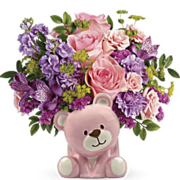 Pink and purple flower arrangement with a pink teddy bear container