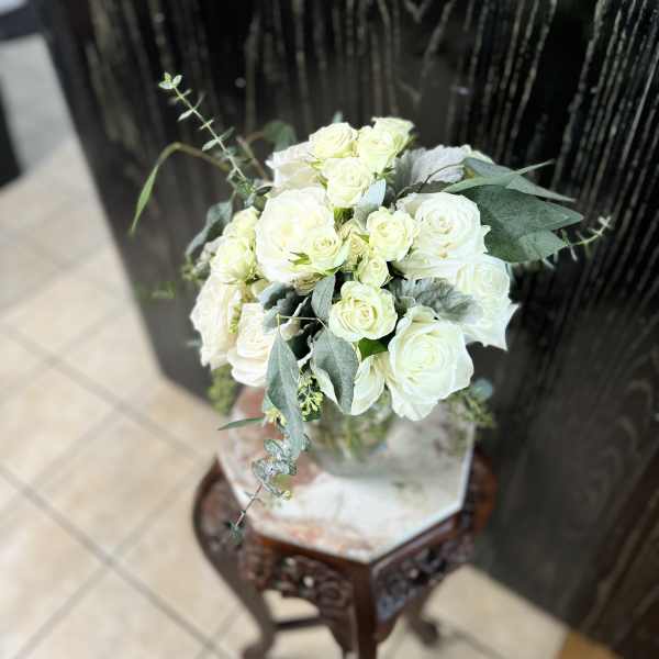 White rose bouquet with eucalyptus in a glass vase