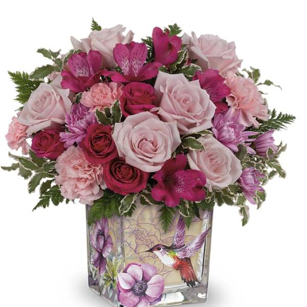 Pink roses and alstroemeria in a decorative glass vase