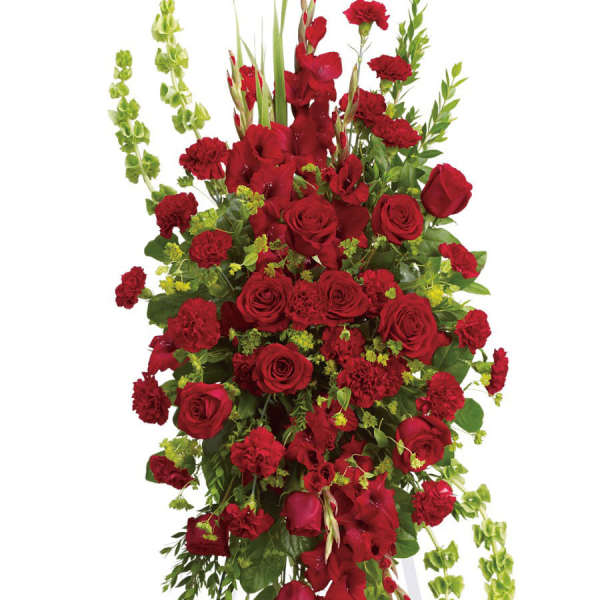 Tall red floral spray with roses and carnations on a white stand