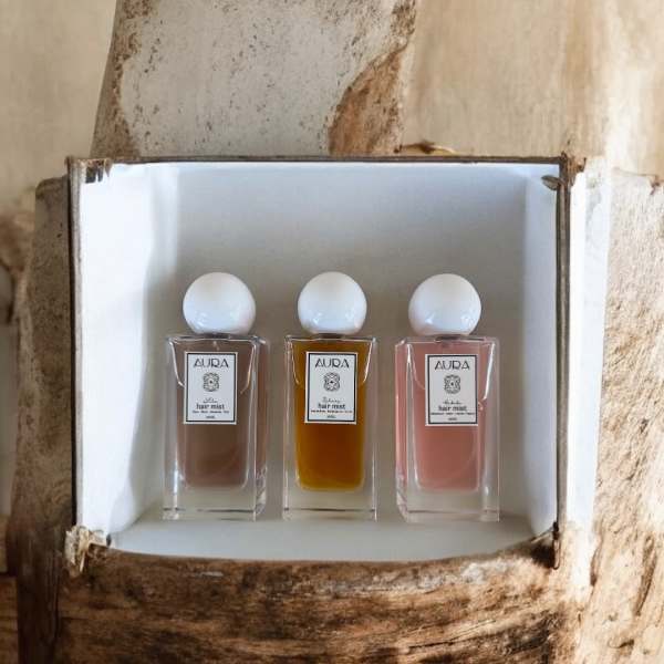 Three small perfume bottles in a white box