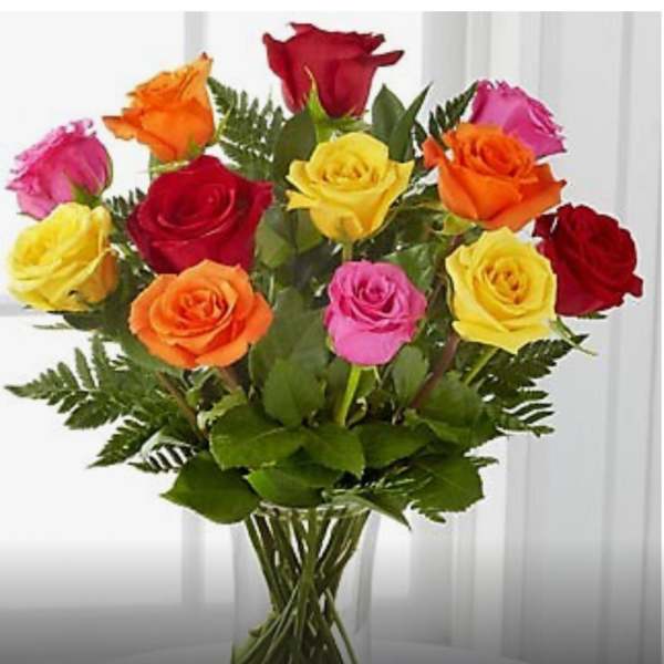 Mixed-color roses in a clear glass vase