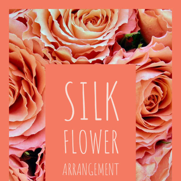 Silk flower arrangement with peach roses and a coral label