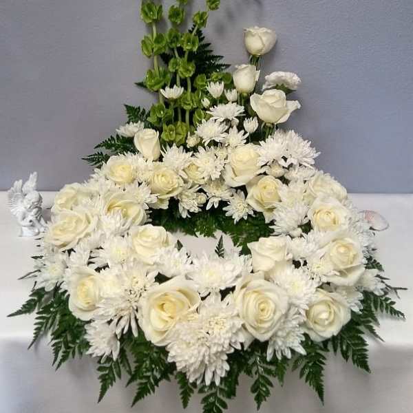 White rose and chrysanthemum floral arrangement with green accents