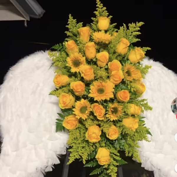 Yellow rose and sunflower standing spray with white angel wings