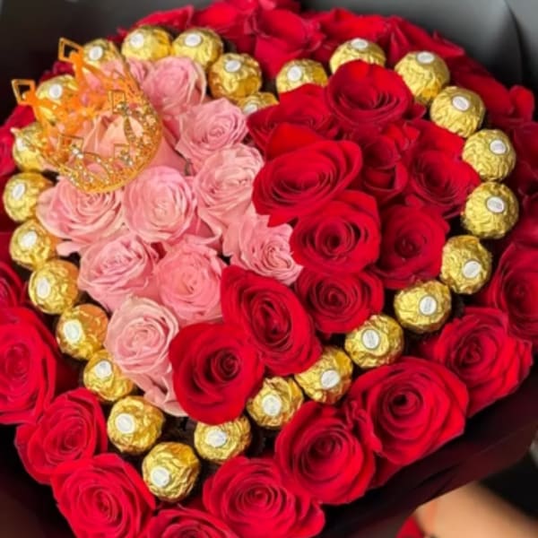 Heart-shaped bouquet of red and pink roses with gold-wrapped chocolates