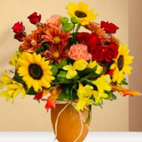 Bouquet of sunflowers, red roses, and orange mums in a vase
