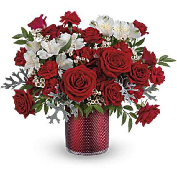 Red and white flower arrangement in a red vase