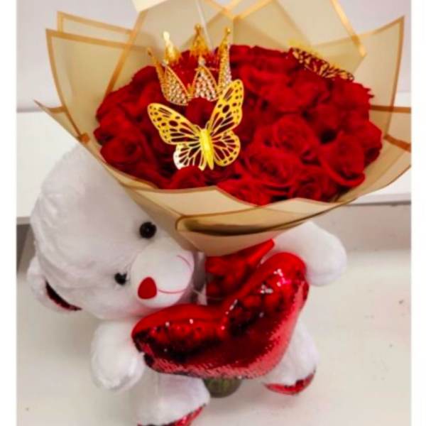 Red rose bouquet with a teddy bear holding a heart