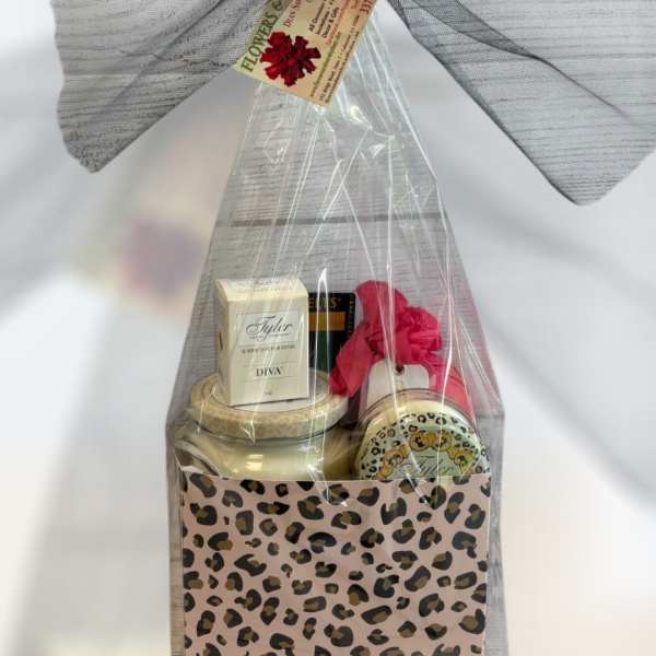 Gift basket with candles and bath items in leopard-print packaging