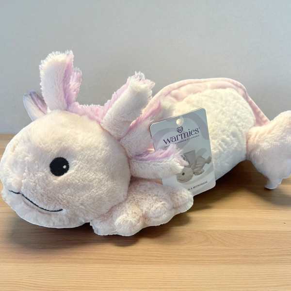 Plush pink-and-white axolotl toy with a product tag