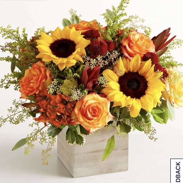 Sunflower and orange rose arrangement in a wooden cube vase