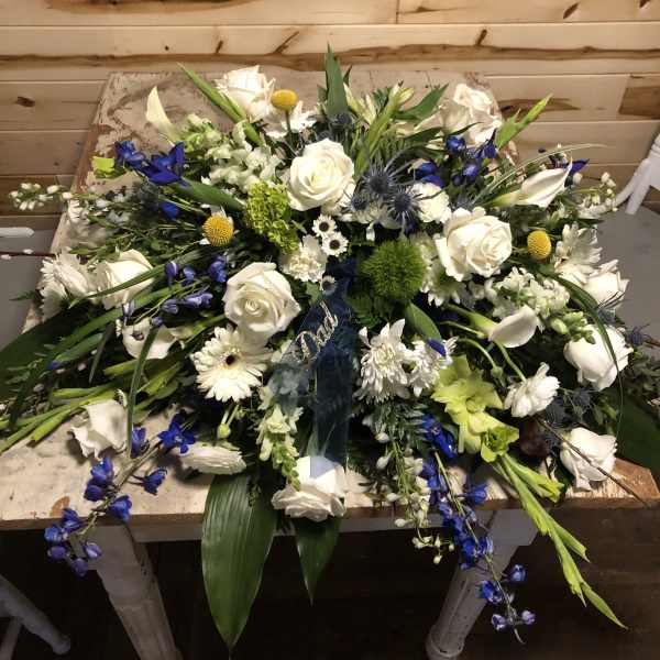Large white and blue floral spray with roses and lilies