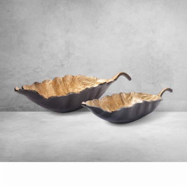 Two decorative leaf-shaped bowls with gold interiors and dark exteriors