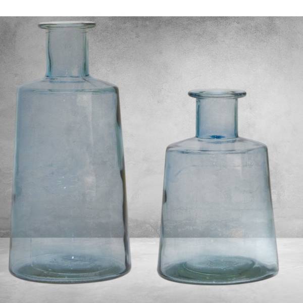 Two blue glass vases on a gray surface