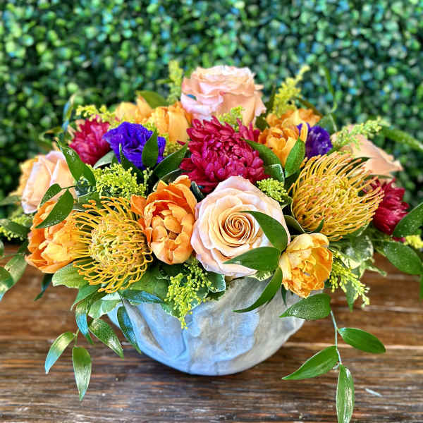 Colorful mixed bouquet in a pale blue vase