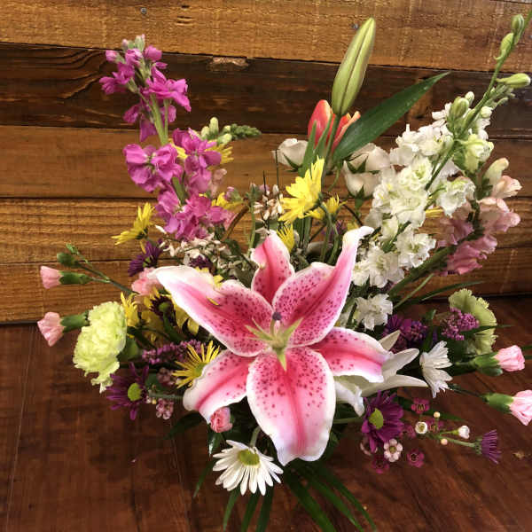 Mixed bouquet with a pink stargazer lily and colorful blooms